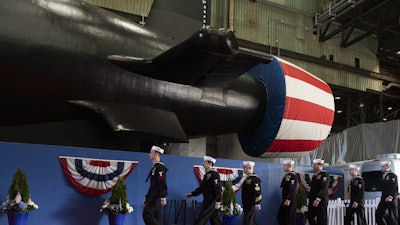 The crew of the pre-commissioning unit (PCU) Idaho (SSN 799) march in formation during a christening ceremony at General Dynamics Electric Boat shipyard facility in Groton, Conn., March 16, 2024.