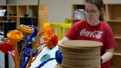A bouquet of vinyl flowers are seen as Tannika Benjamin works at the United Record Pressing plant July 11, 2024, in Nashville, Tenn.