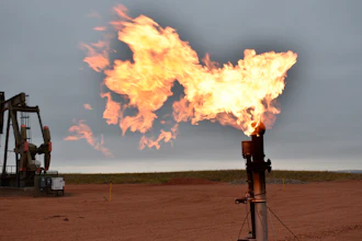 A flare burns natural gas at an oil well in Watford City, N.D.