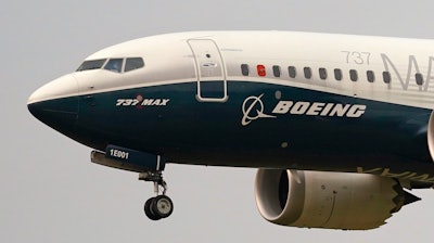 A Boeing 737 Max jet prepares to land at Boeing Field following a test flight in Seattle.