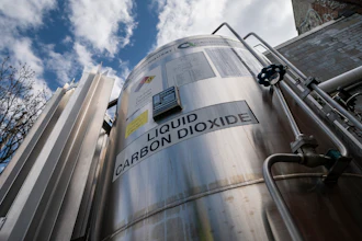 A liquid carbon dioxide containment unit stands outside the fabrication building of Glenwood Mason Supply Company, April 18, 2023, in the Brooklyn borough of New York.