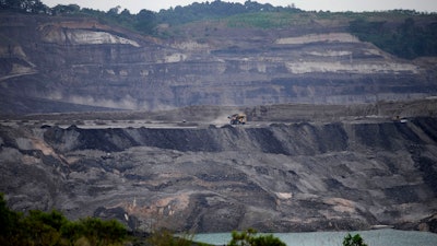 A dump truck carrying coal navigates its way near a coal mining pit in Sanga-Sanga, East Kalimantan, Indonesia, Dec. 20, 2022.
