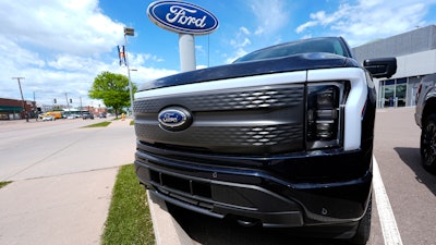 An unsold 2024 Lightning electric pickup truck sits at a Ford dealership May 19, 2024, in Denver.