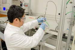 WVU researcher Yuxin Wang loads polypropylene into a microwave reactor. Wang is leading a study that explores the use of microwave technology in plastic upcycling.