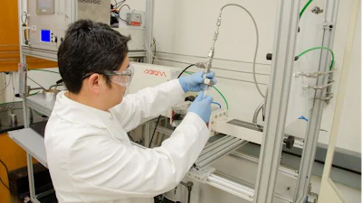 WVU researcher Yuxin Wang loads polypropylene into a microwave reactor. Wang is leading a study that explores the use of microwave technology in plastic upcycling.