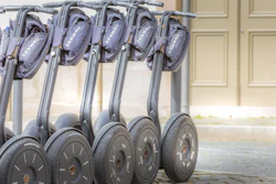 A line of segways awaiting tourist use.