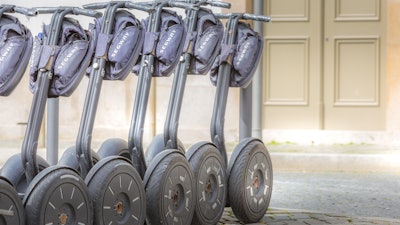 A line of segways awaiting tourist use.
