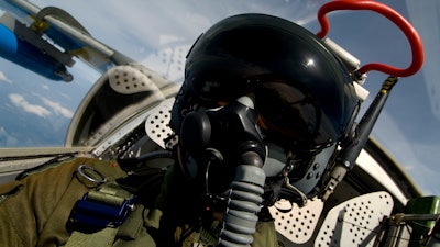 Military jet pilot in the cockpit of an aircraft.