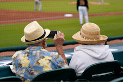 Baseball fans watch a spring training exhibition baseball game between the Pittsburgh Pirates and the Baltimore Orioles in Bradenton, Fla., March 22, 2021.