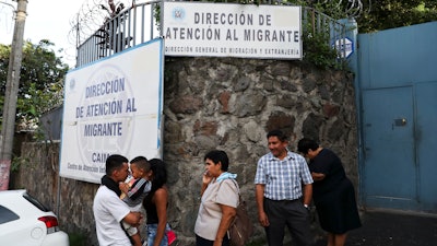 People gather outside the Migrant Assistance Office on Oct. 9, 2019 in San Salvador, El Salvador.