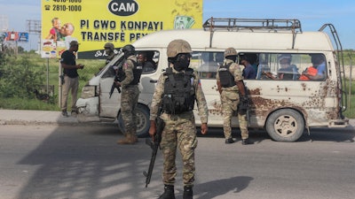 Police officers patrol near the Toussaint Louverture International Airport in Port-au-Prince, Haiti, Tuesday, Nov. 12, 2024.