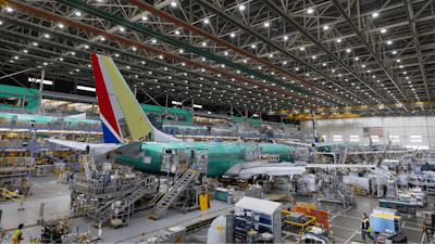 Boeing employees work on the 737 MAX on the final assembly line at Boeing's Renton plant, June 15, 2022, in Renton, Wash.