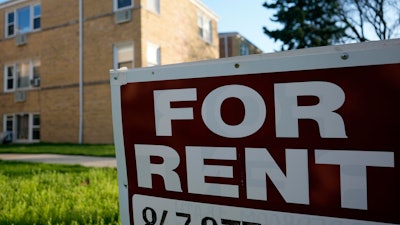 A sign is displayed outside an apartment building in Skokie, Ill., April 14, 2024.