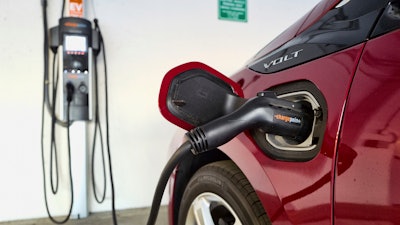 An electric vehicle is charged at a parking garage in Los Angeles, Oct. 17, 2018.