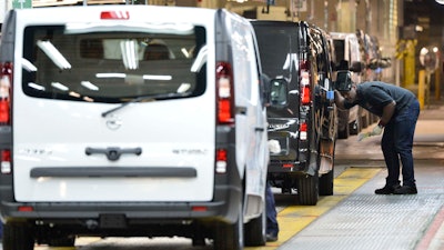 An employee inspects a car at the Vauxhall vehicle production plant in Luton, England, Feb. 2, 2015.