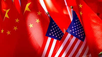 American flags are displayed with Chinese flags on top of a trishaw on Sept. 16, 2018, in Beijing.