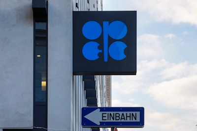 The logo of the Organization of the Petroleoum Exporting Countries (OPEC) is seen outside of OPEC's headquarters in Vienna, Austria, March 3, 2022. A street sign that says „one way' is positioned below the logo.
