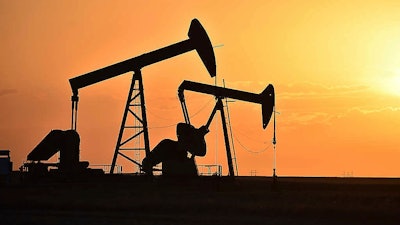Pump jacks extract oil from beneath the ground in North Dakota, May 19, 2021.