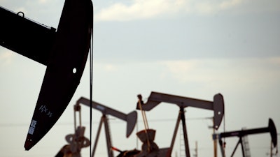 Pump jacks work in a field near Lovington, N.M., April 24, 2015.