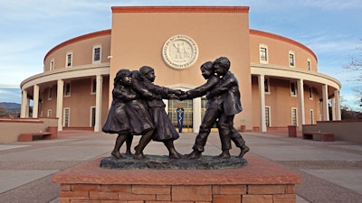 The Tug 'O War' sculpture by artist Glenna Goodacre sits at the entrance to the New Mexico State capitol building in Santa Fe, N.M., on Jan. 13, 2021.