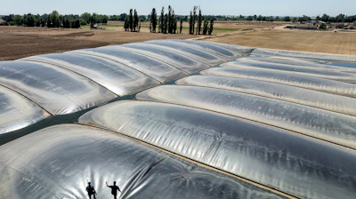 Robbie Macias, Aemetis vice president of biogas, with Wickstrom Jersey Farms manager Brent Wickstrom on a dairy digester in Hilmar, Calif., May 9, 2024.