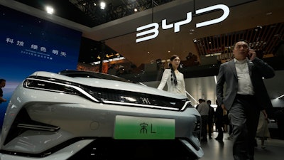 A model poses near the BYD Song L EV car during Auto China 2024 held in Beijing, April 25, 2024.