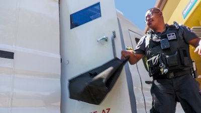 A Loomis security guard with cash in hand.