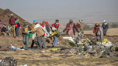 Debris is carried at the scene of an Ethiopian Airlines flight crash near Bishoftu, or Debre Zeit, south of Addis Ababa, Ethiopia, on March 11, 2019.