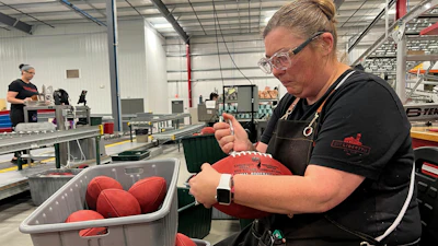 Wilson Sporting Goods football factory employee Nicole Rainsburg inspects the Super Bowl game balls before they are ready to be shipped Monday, January 27, 2025, in Ada, Ohio.