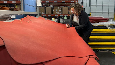 Sarena Hardia, inspects the material before it is cut into the shape of a football for the upcoming Super Bowl matchup between the Philadelphia Eagles and the Kansas City Chiefs inside the Wilson Sporting Goods football factory, Monday, January 27, 2025, in Ada, Ohio.