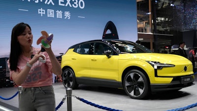 A live streamer works near the Volvo EX30 fully electric small SUV unveiled during Auto China 2024 in Beijing, Thursday, April 25, 2024.