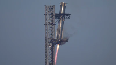 SpaceX's mega rocket Starship booster returns to the launch pad during a test flight from Starbase in Boca Chica, Texas, Thursday, Jan. 16, 2025.