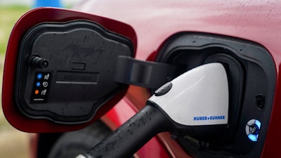 A 2023 Ford Mustang Mach-E charges, March 8, 2024, at an electric vehicle charging station in London, Ohio.