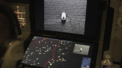Crew members aboard a French Navy Atlantique 2 surveillance plane patrolling Thursday, Jan. 23, 2025, over the Baltic Sea as part of the NATO military alliance's 'Baltic Sentry' mission to protect undersea cables and pipelines from sabotage watch one of the onboard monitors showing images from the aircraft's cameras of a ship navigating on the Baltic.