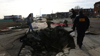 This image released by the NTSB on Tuesday, Feb. 4, 2025 shows the site of initial impact of the Learjet 55 that crashed on Jan. 31 in Philadelphia.