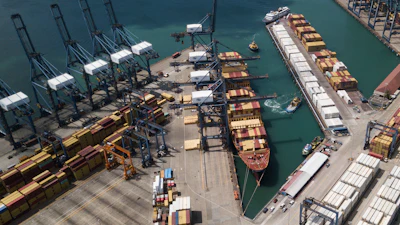 Cranes load and unload containers from cargo ships at the Cristobal port, operated by the Panama Ports Company, in Colon, Panama, Tuesday, Feb. 4, 2025.