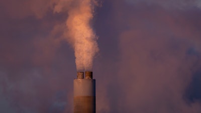 Carbon dioxide and other pollutant billows from a stack at PacifiCorp’s coal-fired Naughton Power Plant, near where Bill Gates company, TerraPower plans to build an advanced, nontraditional nuclear reactor, Jan. 13, 2022, in Kemmerer, Wyo.