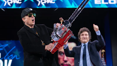 Elon Musk, left, receives a chainsaw from Argentina's President Javier Milei as they arrive speaks at the Conservative Political Action Conference, CPAC, at the Gaylord National Resort & Convention Center, Thursday, Feb. 20, 2025, in Oxon Hill, Md.