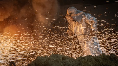 A worker in protective clothes melts steel at the Zaporizhstal Iron and Steelworks, one of the country's largest steel plants, in Zaporizhzhia, Ukraine, Thursday, Feb. 13, 2025.