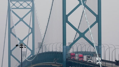 Trucks enter into the United States from Ontario, Canada across the Ambassador Bridge, Monday, Feb. 3, 2025, in Detroit.