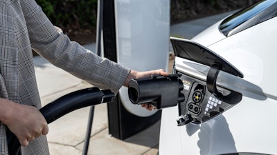 The Hyundai NACS adapter being plugged into a 2024 IONIQ 5.
