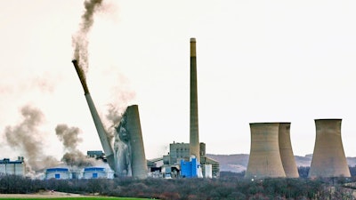 The smokestacks of the former coal-fired Homer City Generating Station crumble in a planned demolition to make way for a new natural gas-fired power plant in Homer City, Pa., Saturday, March 22, 2025.