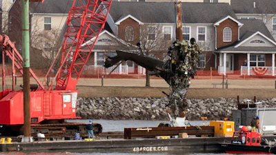 Rescue and salvage crews pull up a part of a Army Black Hawk helicopter that collided midair with an American Airlines jet, at a wreckage site in the Potomac River from Ronald Reagan Washington National Airport, Feb. 6, 2025, in Arlington, Va.