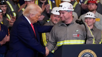 President Donald Trump shakes hands with coal miner Jeff Crowe during an event on energy production in the East Room of the White House, Tuesday, April 8, 2025, in Washington.