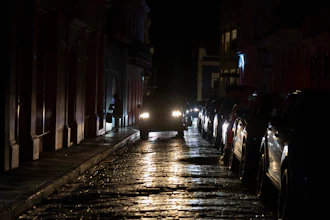 Headlights illuminate cobblestone streets in Old San Juan, Puerto Rico, during an island-wide blackout, Wednesday, April 16, 2025.