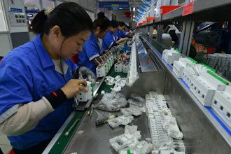 Workers assemble circuit breakers at a manufacturer of electronic equipment, in Fuyang city in central China's Anhui province on April 15, 2025.