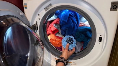 Rachael Z. Miller, founder of the Vermont-based Rozalia Project for a Clean Ocean, tosses a Cora Ball, a laundry ball that can be tossed into the washer to cut down on clothes banging into each other, on Thursday, April 17, 2025, in Granville, VT.