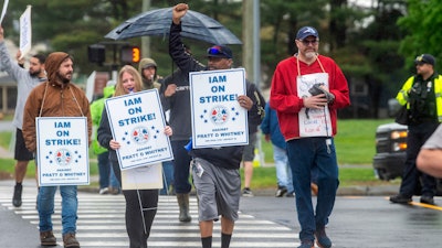 Pratt & Whitney employees hold signs while picketing at the Silver Lane entrance in East Hartford, Conn., on the first day of their strike, Monday, May 5, 2025.