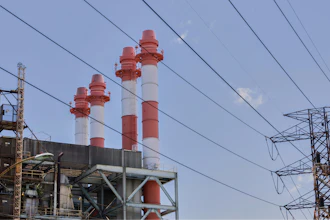 Power lines rise in front of electric towers and smokestacks at the Palo Seco power plant in Toa Baja, Puerto Rico, Thursday, May 8, 2025.