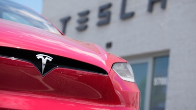 A Model X sports-utility vehicle sits outside a Tesla store in Littleton, Colo., June 18, 2023.